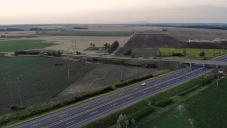 fly above a highway's overpass with a drone after sunset