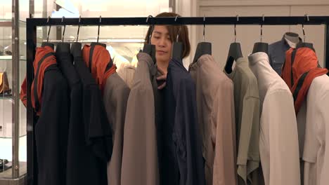 customer shopping for clothes jacket in mall store