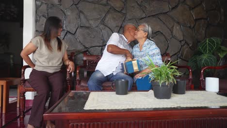 zoom in shot of senior asian mother and adult daughter celebrating father's birthday at home