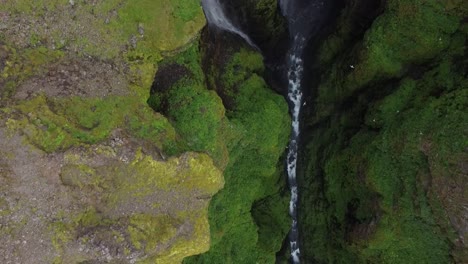 aerial downwards view of glymur waterfall in canyon, iceland