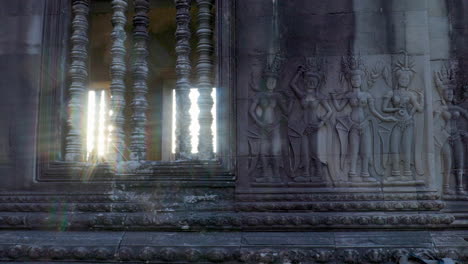 de hermosos grupos de devata, a menudo referidos como bailarines de apsara en las paredes de angkor wat con el estilo del sol estelar y la luz refractiva del arco iris