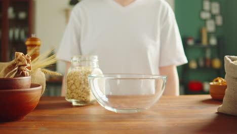 person pouring oats into a bowl