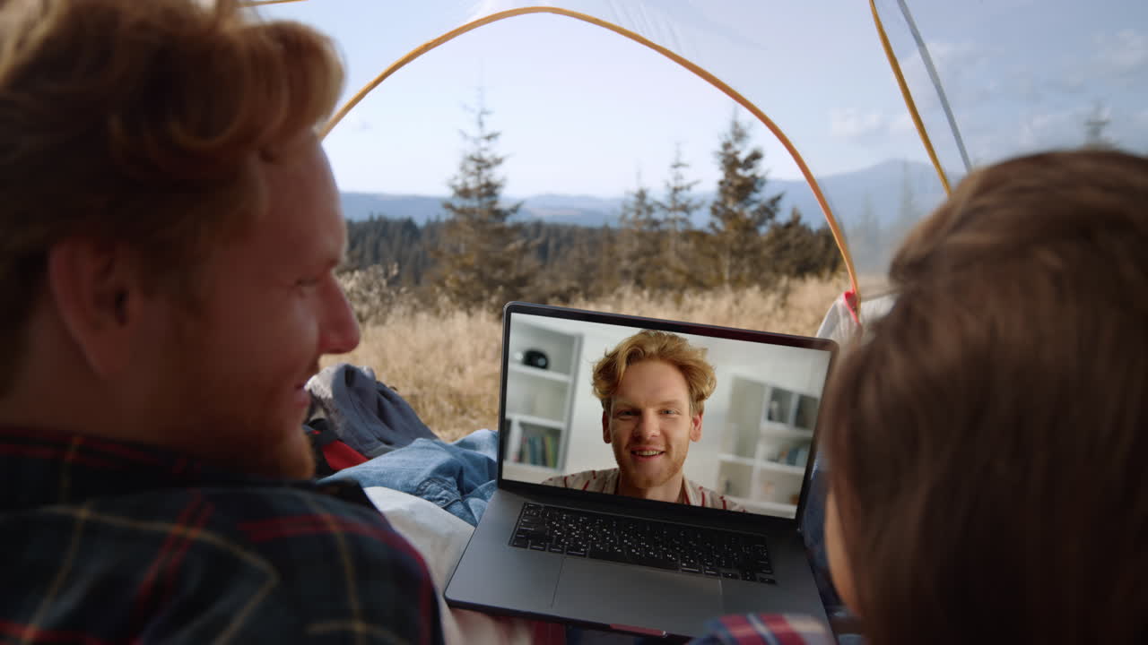 Trip couple calling video conference at mountains. Closeup smiling guy in laptop