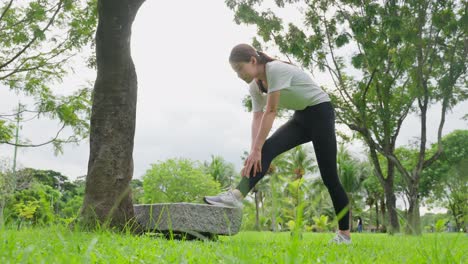 woman stretching in park