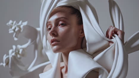 elegant woman in avant-garde white sculptural garment