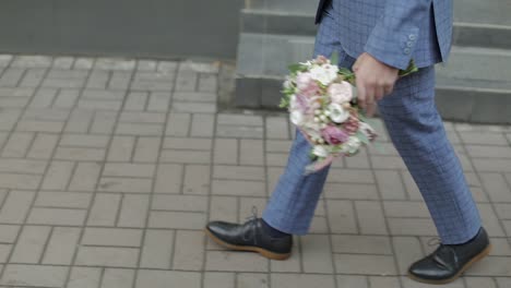 groom walking to his bride holding wedding bouquet in hand. slow motion