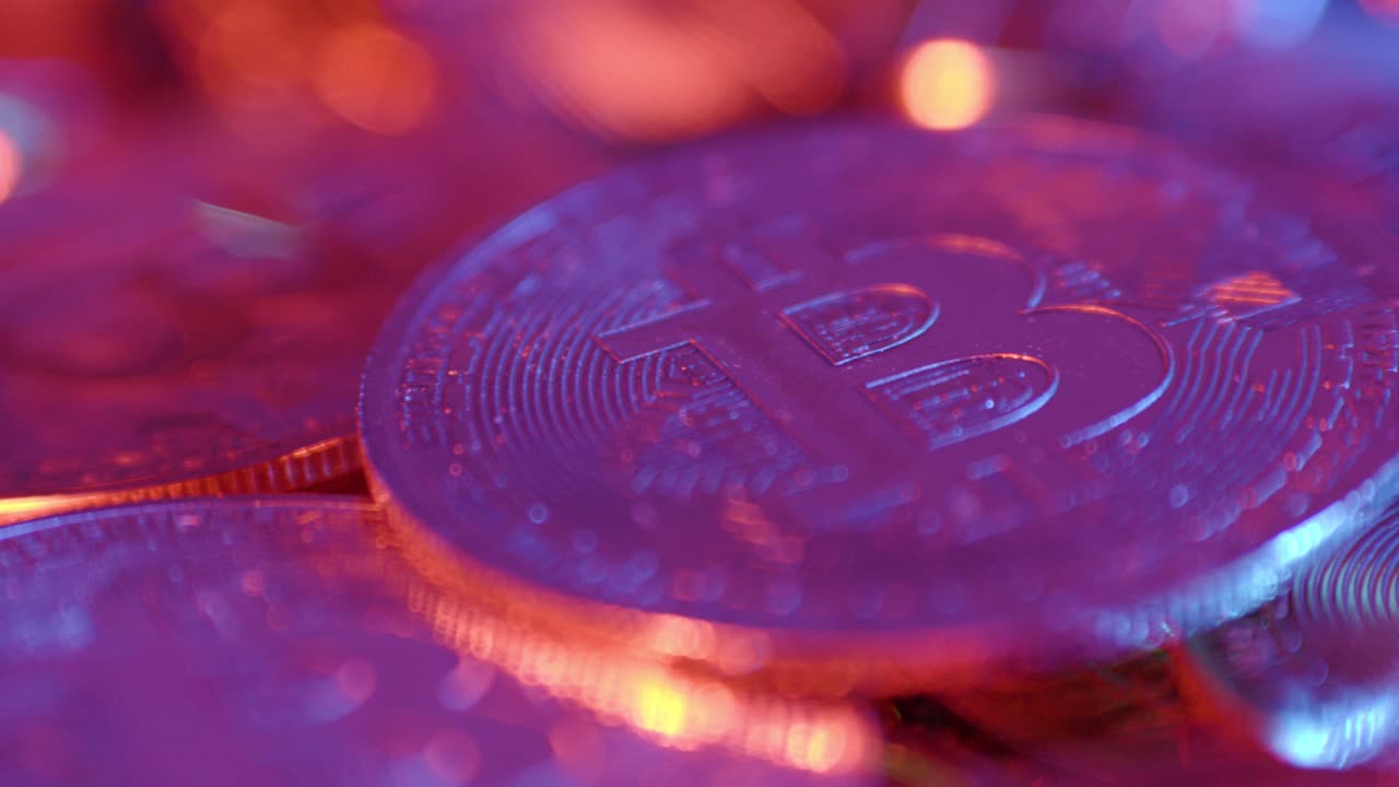 Close Up of Bitcoin Coins in Neon Light