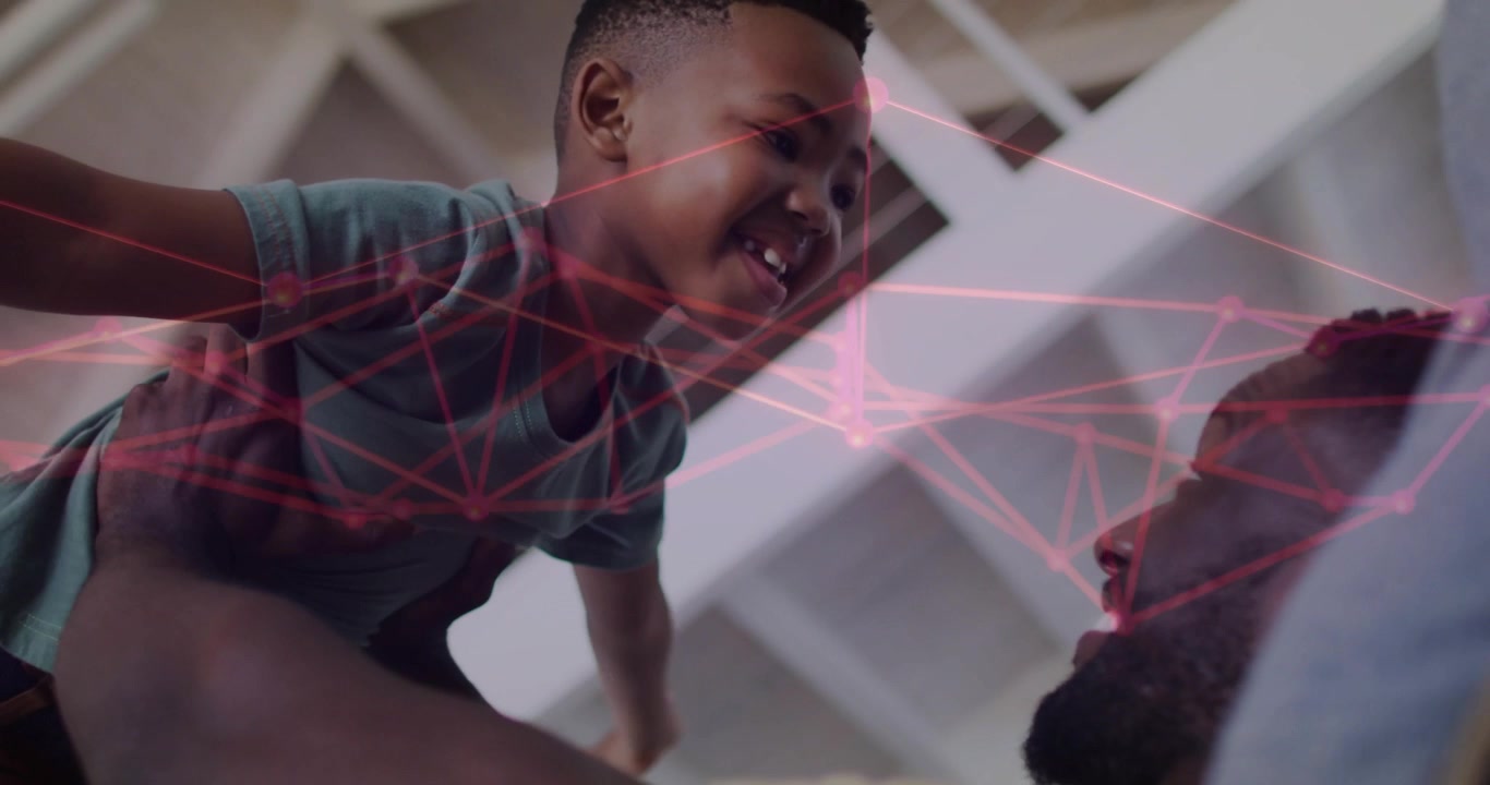 Father lifting son on bed, playing airplane for play, pink network overlaying subjects in tech