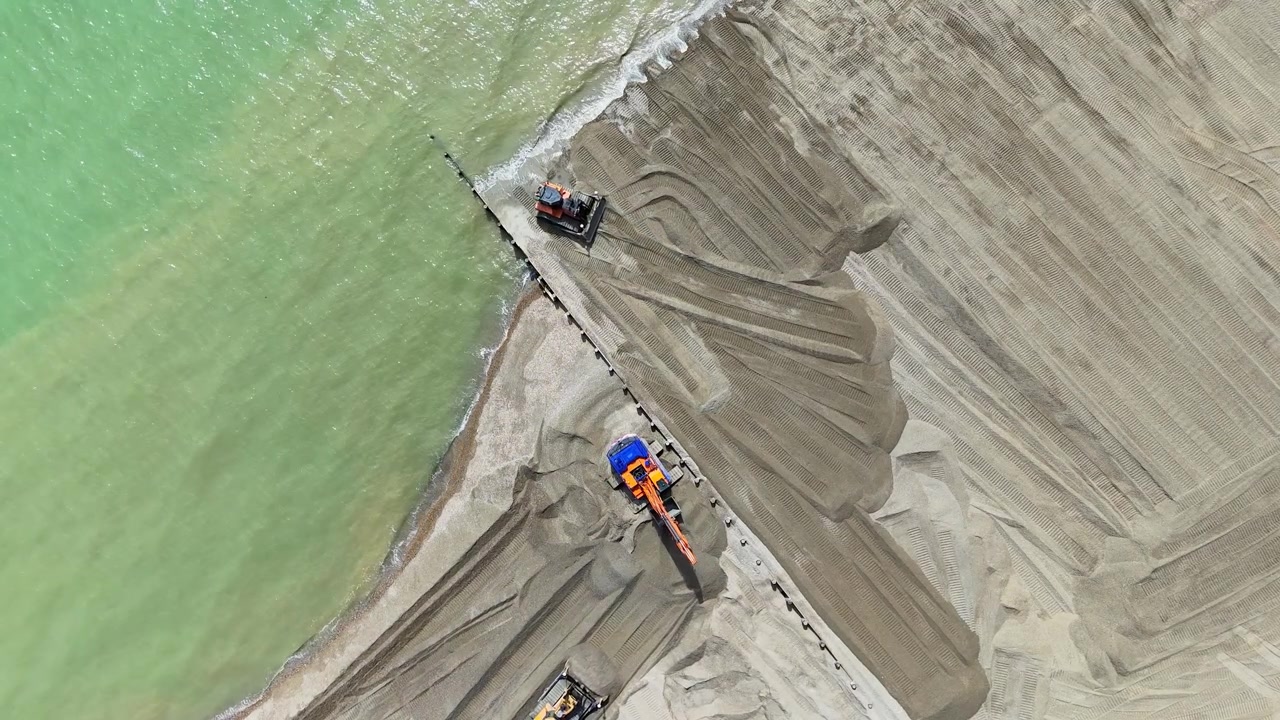 Nuovi pennelli in legno installati trattengono la ghiaia dragata e rafforzano il lungomare contro l'erosione costiera e il rischio di inondazioni. Vista aerea. Hove, East Sussex, Regno Unito