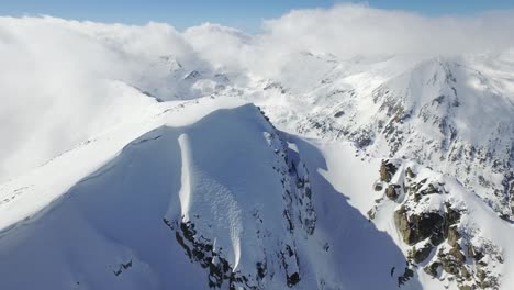 snowy mountain peaks and cloudscape