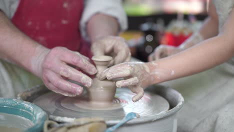 potter teaching pottery little girl