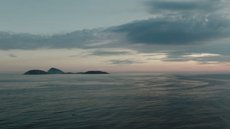 Beach-water-surface,-landscape-and-sky-touching-horizon-at-sunset,-Ipanema-Beach,-Rio-De-Janeiro,-Brazil