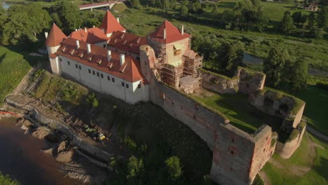 drone aerial looking down at bauska castle, latvia during restoration building works