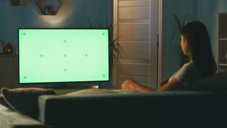mother with kid watching tv in evening