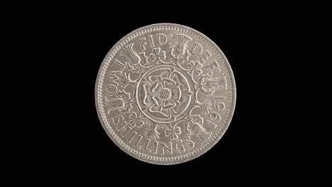 united kingdom 1961 two shillings coin reverse with tudor rose rotating on black background