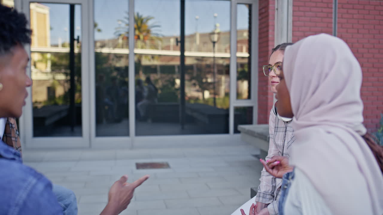 Group of diverse college students talking outside