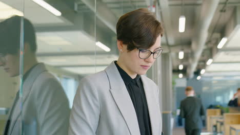 businesswoman texting on smartphone in office