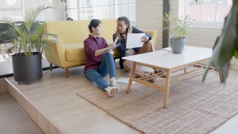 Happy-diverse-business-people-using-tablet-and-discussing-work-in-office-in-slow-motion