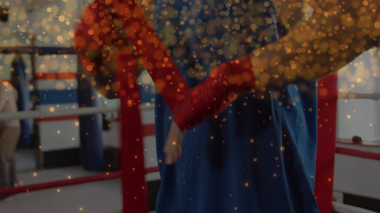 Boxer feeding red wrap thru thumb looping tightening testing, preparing training under gold overlay