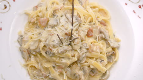 Spaghetti-in-mushroom-sauce-with-grated-cheese,-close-up,-Mediterranean