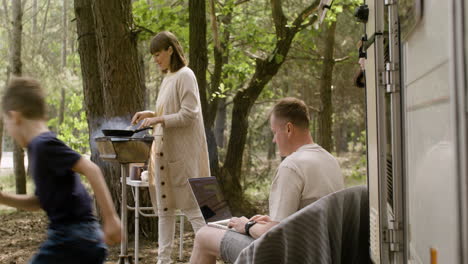 Happy nomad family spending time together at the camping in the forest