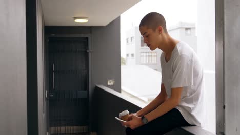 young man having coffee while using mobile phone 4k