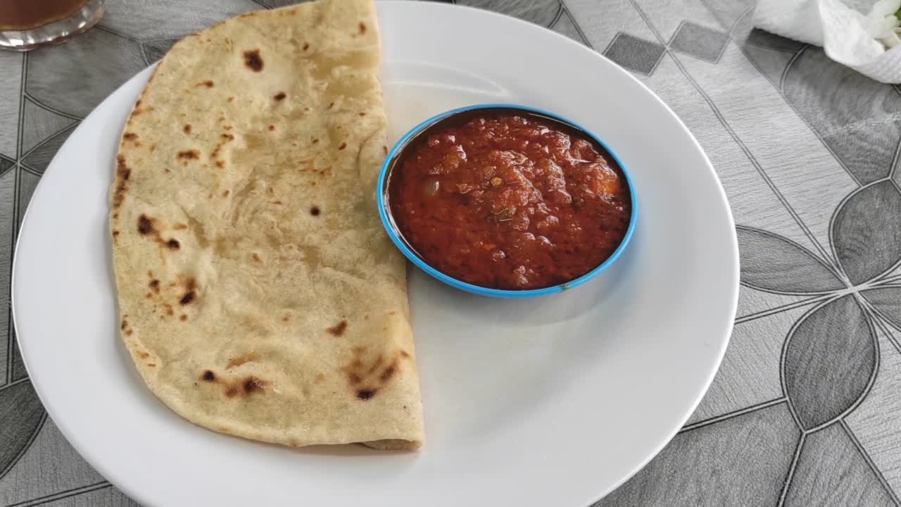 A simple yet flavorful dish featuring soft chapati served with rich sambal sauce. This Indian flatbread, made from wheat flour, pairs perfectly with the spicy, tangy condiment.