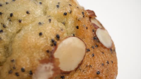 macro shot of lemon poppy seed muffin with almonds