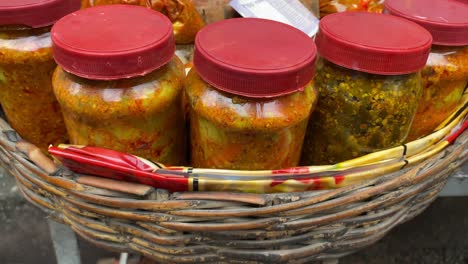 close up shot of street vendors selling wide variety of pickles or aachar in his shop