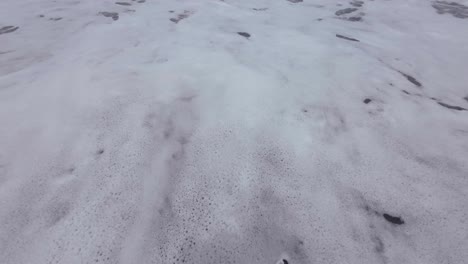 man walking on black sand beach india mumbai vasi rajodi beach