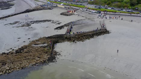 drone descends over diamond rhombus at ladies beach galway ireland