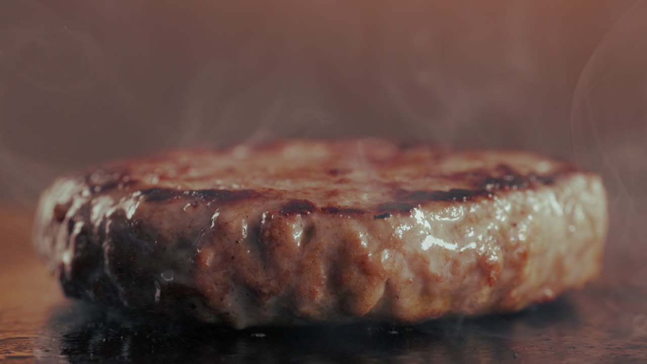 A sizzling hamburger patty