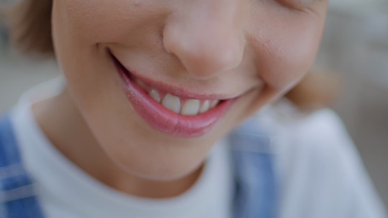 Attractive woman face looking camera with cheerful smile. Closeup lips