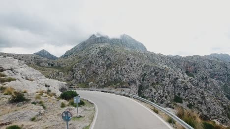 Stunning-drone-shot-in-4k-of-cars-driving-in-serpentines-in-Mallorca,-Serra-de-Tramuntana---Sa-Clobra-curvy-roads-through-mountains