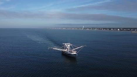 drone shot of a shrimp boat within sight of the shore