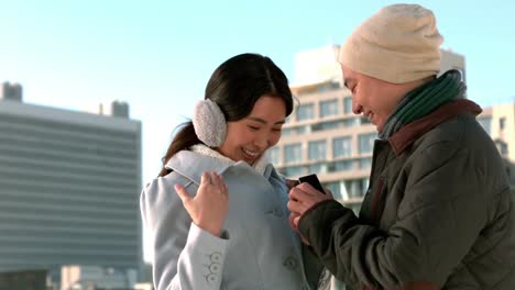 Loving-Asian-couple-in-winter-clothes-engaging