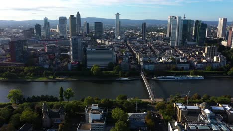 panoramic aerial overview of downtown frankfurt germany at sunset as light spreads across barges and ferries