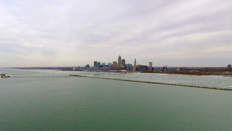 wide revealing drone shot of downtown cleveland ohio and lake erie