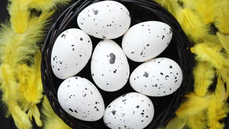 whole chicken eggs in a nest on a black rustic wooden background  easter symbols