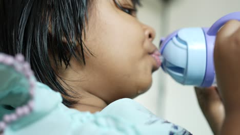 rear view child girl drinking water