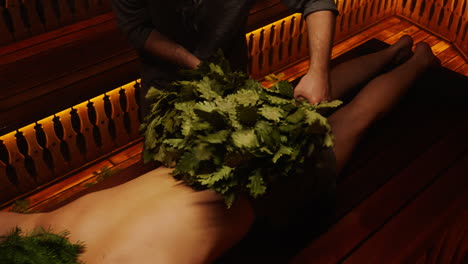 man getting a traditional russian banya treatment