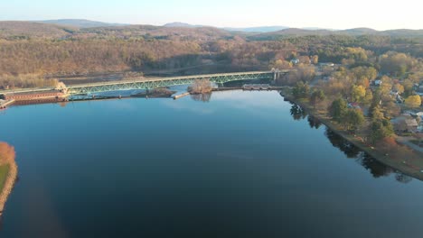 aerial fly-in view over a blue lake in greenfield, massachusetts in the new england area