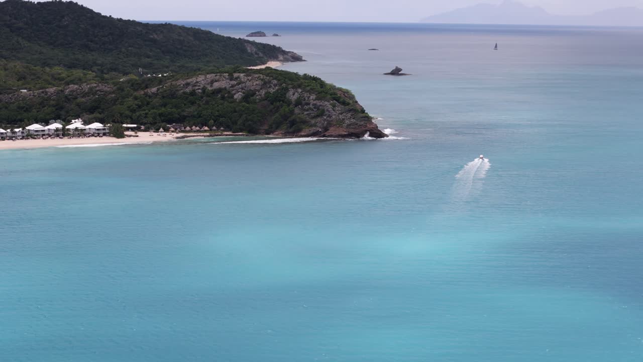 Aerial View of a Tropical Island with Turquoise Water and a Boat