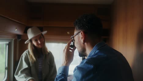 couple taking a picture inside a camper van