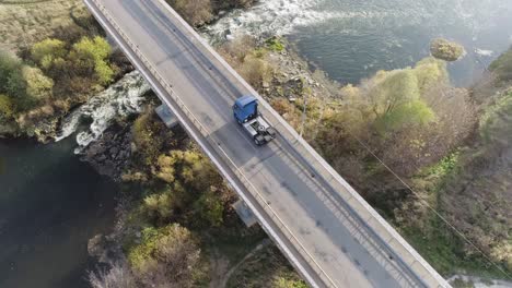 truck on a bridge over a river