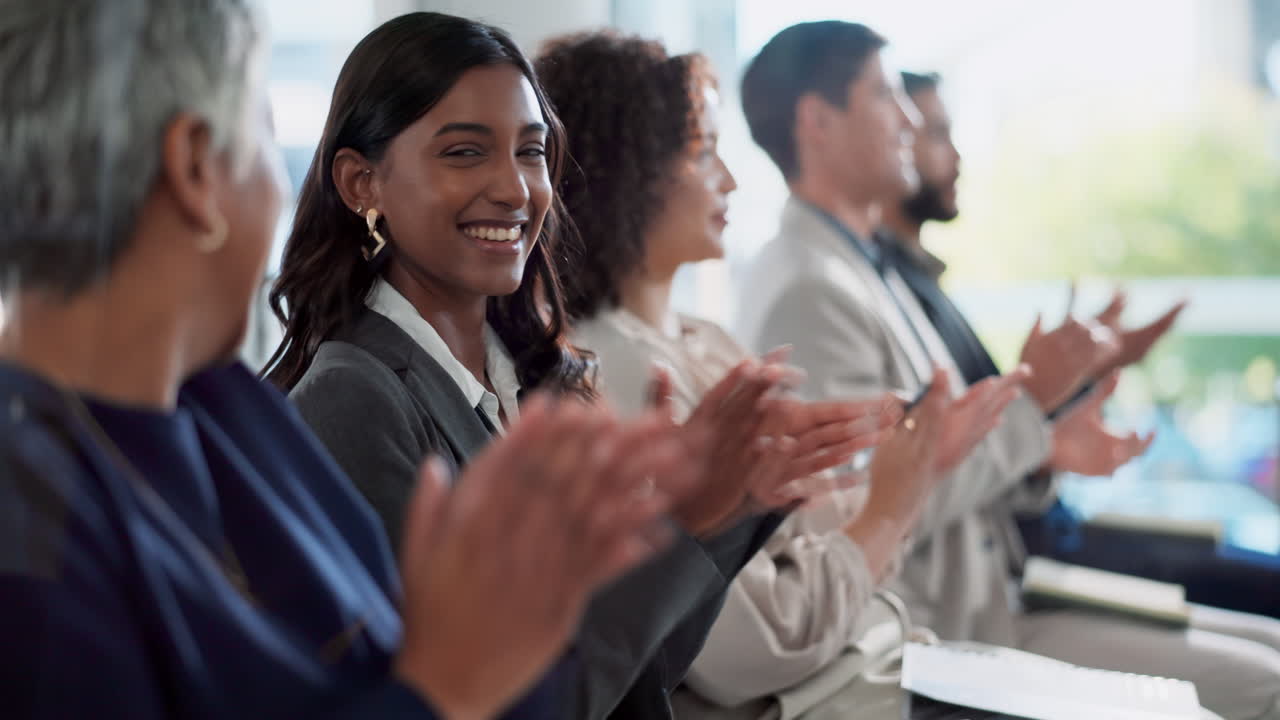 Diverse business team applauding at a conference