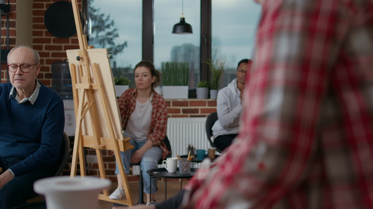 Multiethnic group of people attending art class lesson