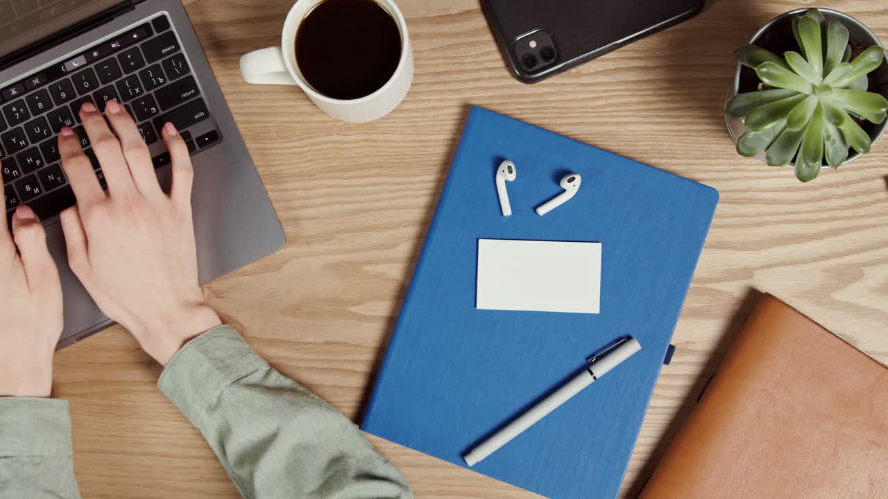 Person Working at a Desk with Laptop and Other Essentials