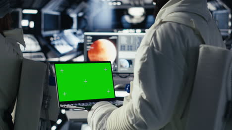 astronauts reviewing onboard analytics on isolated screen tablet