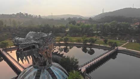 Vista-Aérea-Del-Parque-Acuático-Abandonado-Del-Lago-Thuy-Tien-Con-Un-Gran-Dragón